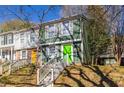Two-story townhome with green siding and a bright green front door at 845 Regal Path Ln, Decatur, GA 30030