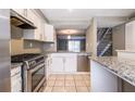 Kitchen with stainless steel appliances, granite countertops, and open floorplan view to living room and stairs at 845 Regal Path Ln, Decatur, GA 30030