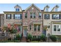 Charming townhome showcasing a brick facade, black shutters, and manicured landscaping at 1829 Hislop Ln, Atlanta, GA 30345