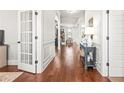 Elegant hallway with hardwood floors, white wainscoting, and open doorway at 3314 Ridge Manor Way, Dacula, GA 30019