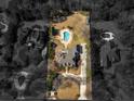 A captivating aerial shot of an estate featuring a kidney-shaped pool nestled within a verdant landscape and luxury homes at 8531 N Shore Dr, Jonesboro, GA 30236