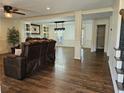 Open living room featuring hardwood floors, crown molding, a ceiling fan, and an open concept at 4184 Westchester Ne Trce, Roswell, GA 30075