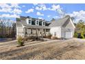Inviting two-story home with a covered porch and well-maintained landscaping at 411 Spring Lake Hls, White, GA 30184