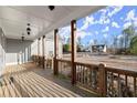 Spacious front porch with wood railings and an open view of the surrounding landscape at 411 Spring Lake Hls, White, GA 30184