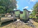 View of the backyard of fire-damaged building with rubble on the ground at 2022 Cook Rd, Decatur, GA 30032