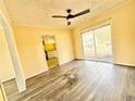 Living room featuring laminate wood flooring, yellow walls, and a sliding glass door at 2022 Cook Rd, Decatur, GA 30032
