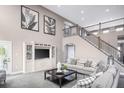Spacious living room with a two-story ceiling, staircase, and stylish neutral decor at , Locust Grove, GA 30248