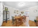 Formal dining room featuring hardwood floors, decorative moldings, and a classic table setting at 2086 Mountain Creek Ct, Stone Mountain, GA 30087