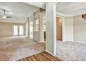 Spacious living room with neutral carpet, decorative columns and doorways, and bright light from the windows at 501 Barhams Ridge Dr, Mcdonough, GA 30252