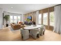 Open concept living and dining area showcasing modern furnishings, including a stylish table at 2437 Red Maple Se Xing # 122, Smyrna, GA 30080
