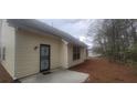 Exterior of the home featuring vinyl siding and a concrete patio at 1956 Cutters Mill Way, Lithonia, GA 30058