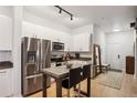 Modern kitchen with stainless steel appliances, eat-in bar, and granite countertops offers sleek design at 5300 Peachtree Rd # 0507, Atlanta, GA 30341