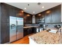 Modern kitchen boasts stainless steel appliances, granite countertops, and dark wood cabinetry at 1080 Peachtree Ne St # 1208, Atlanta, GA 30309