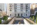 Elegant building entrance featuring manicured landscaping and convenient parking garage access at 195 14Th Ne St # 2105, Atlanta, GA 30309