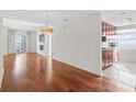 Open-concept living area with hardwood floors, adjacent to a modern kitchen at 195 14Th Ne St # 2105, Atlanta, GA 30309