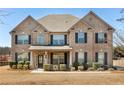 Elegant two-story brick home with symmetrical design and a welcoming front porch at 141 Aylesbury Blvd, Mcdonough, GA 30252