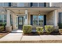 Charming front porch with classic columns and beautifully trimmed shrubs at 141 Aylesbury Blvd, Mcdonough, GA 30252