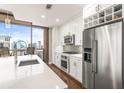 Modern kitchen featuring stainless steel appliances, white cabinets, and city views at 270 17Th Nw St # 2002, Atlanta, GA 30363