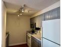 Efficient kitchen with gray cabinets, white appliances, and overhead lighting at 375 Ralph Mcgill Ne Blvd # 1402, Atlanta, GA 30312