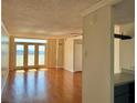 Open living room with access to a private balcony and lovely hardwood floors at 375 Ralph Mcgill Ne Blvd # 1402, Atlanta, GA 30312