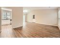 Bright and airy living room featuring wood floors, vaulted ceiling, and a view into the kitchen area at 2436 Wilshire Ct, Decatur, GA 30035