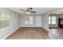 Inviting living room featuring sleek wood floors, abundant natural light, and a ceiling fan at 346 Henry Aaron Sw Ave, Atlanta, GA 30310
