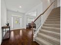Inviting foyer with hardwood floors, a staircase, and views into the formal living room at 644 Crystal Cove Ct, Loganville, GA 30052