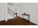 Inviting foyer with hardwood floors, a staircase, and views into the formal living room at 644 Crystal Cove Ct, Loganville, GA 30052