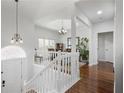 Bright entryway with white staircase, hardwood floors, and views into the dining area and other living spaces at 1772 Ascot Nw Run, Acworth, GA 30102
