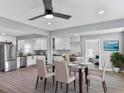 Bright dining room with modern ceiling fan, flows into the kitchen with stainless appliances at 5205 Silhouette Sw Ln, Mableton, GA 30126