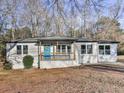 Charming ranch-style home featuring a covered front porch with a bright blue front door at 5205 Silhouette Sw Ln, Mableton, GA 30126