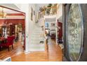 A light-filled foyer with hardwood floors, staircase and view to the dining room and living room at 11 Tallulah Ct, Jonesboro, GA 30236