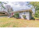 A charming home features a well-maintained yard and gray painted brick at 2818 Mcafee Rd, Decatur, GA 30032