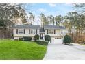 Charming home with a well-manicured lawn, a split level floorplan, and an attached garage at 326 Bethel Dr, Woodstock, GA 30189