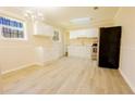 Well-lit kitchen with white cabinets, stainless steel appliances, and vinyl flooring at 8684 Chestnut Ln, Lithia Springs, GA 30122
