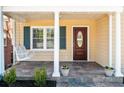 Inviting front porch with a classic swing, neutral tones, and stylish slate tile flooring at 239 Lindbergh Ne Dr, Atlanta, GA 30305