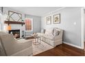 Cozy living room with a decorative fireplace, wood floors, and neutral color palette at 239 Lindbergh Ne Dr, Atlanta, GA 30305