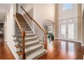 Elegant foyer featuring hardwood floors, a staircase, and double doors with decorative glass at 6350 Old Wood Hollow Way, Buford, GA 30518