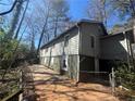 Side view of two-story home featuring green siding, white trim and fenced yard at 80 Harlan Sw Rd, Atlanta, GA 30311