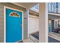 Close up of a vibrant blue entry door, garage, and exterior with gray siding at 1059 Park Row North Se, Atlanta, GA 30312