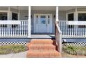 Inviting front porch with classic white railings and brick steps lead to the decorative front door at 1294 Summit Chase Dr, Snellville, GA 30078