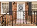 Close-up of a front door with iron railings and brick facade at 4555 Cedar Heights Ct, Stone Mountain, GA 30083