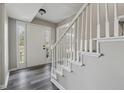 Bright foyer with white trim staircase, luxury vinyl flooring and sidelight windows at 4809 Thompson Mill Rd, Lithonia, GA 30058