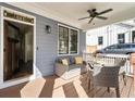 Inviting front porch with comfortable seating area features a ceiling fan and view to the exterior at 625 Glenwood Se Pl, Atlanta, GA 30316