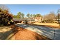 Street view of brick home with mature trees, a long drive, and professional landscaping at 1654 Deerfield Cir, Decatur, GA 30033