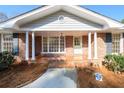 Inviting brick front porch with columns, painted door, and large window for ample natural light at 1654 Deerfield Cir, Decatur, GA 30033