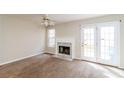 Bright living room featuring fireplace, ample natural light, and neutral carpet at 6347 Wellington Walk Way, Lithonia, GA 30058