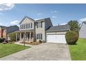 Well-kept home features an attached garage and a neatly maintained front lawn at 2311 Fall Creek Lndg, Loganville, GA 30052