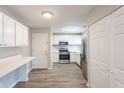 Updated kitchen features white cabinets, modern appliances and convenient breakfast bar at 6939 Hickory Log Rd, Austell, GA 30168