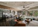 Open-concept living space features a comfortable sofa, exposed ceilings, and large windows at 890 Memorial Se Dr # 101, Atlanta, GA 30316